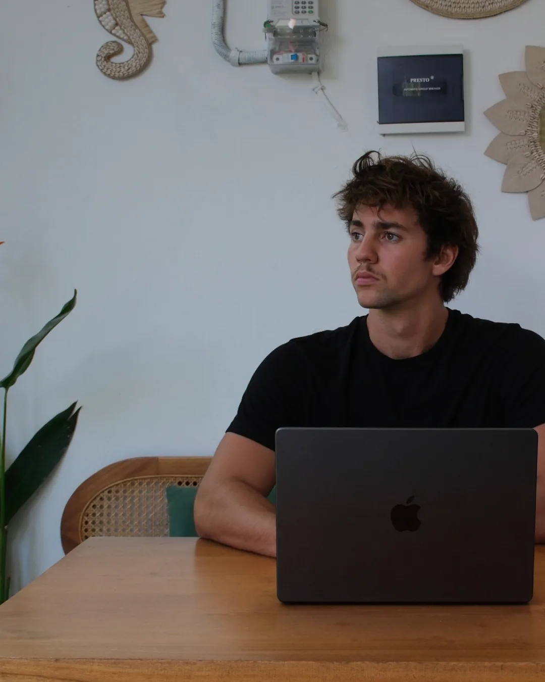 Adrien Ninet at a table with his laptop