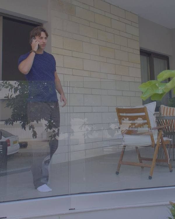Adrien on a call on his balcony